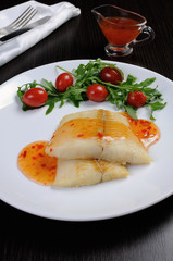 Flounder fillets in sauce with arugula and cherry tomatoes