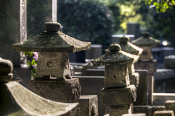Fototapeta na wymiar Japanese cemetery with stone lanterns
