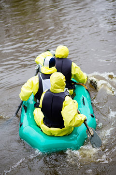 People In Overcrowded Rubber Boat