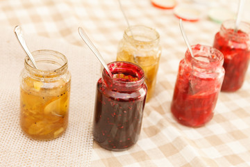 Fototapeta na wymiar different jars full of fruity jam