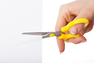Hand with yellow scissors