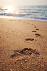 Footprints on the beach sand.Traces on the beach. Footsteps on t