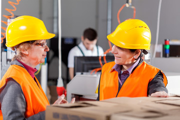 Employees discussing at production area