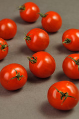 small tomatoes on grey background