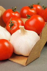 tomatoes with garlic close up in a brown box