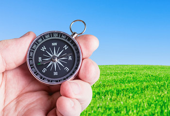 compass in hand on nature background