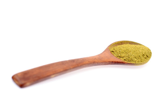 Green Spice in Wooden Spoon Isolated on White Background