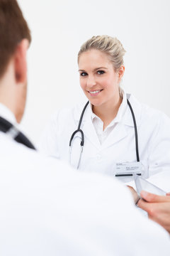 Doctor Looking At Colleague In Meeting