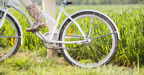 Fototapeta na wymiar Detial of young woman with bike