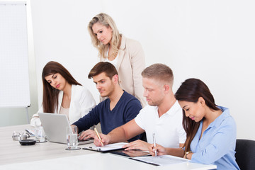 Businesspeople Studying At Desk