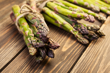 Bunch of young asparagus on wooden table
