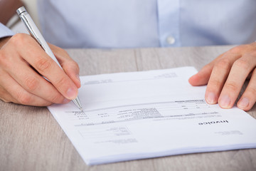 Businessman Calculating Accounts