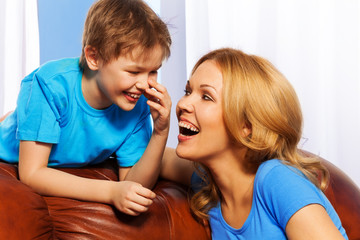 Portrait of smiling mother and son at home