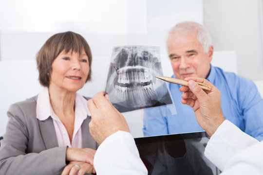 Dentist Explaining X-Ray To Senior Couple