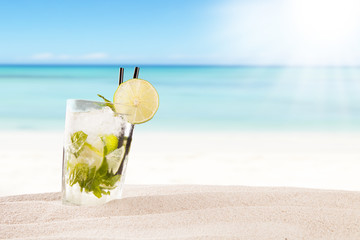 Summer mojito drink with blur beach on background