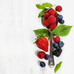 Berries with spoon  on Wooden Background. Health, Diet, Gardenin