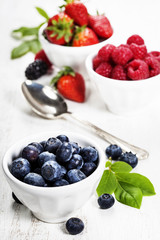 Berries in bowls  on Wooden Background.