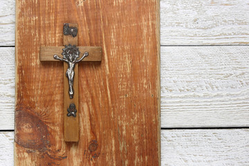 Wooden cross on wooden background