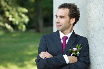 Groom standing near column