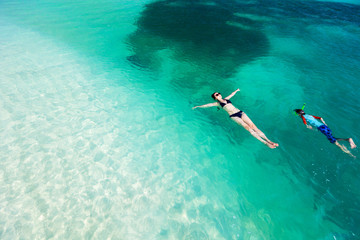 Obraz premium Mother and son swimming in ocean