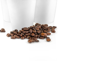 Set of white take-out coffee cups and coffee beans
