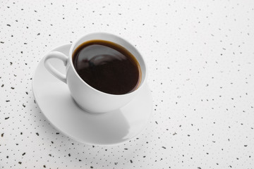 Cup of coffee on spotty background