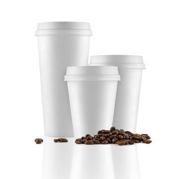 Set of white take-out coffee cups and coffee beans