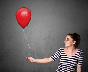 Woman holding a red balloon