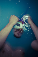 Obraz na płótnie Canvas Depression, man in blue tub full of water, sadness concept