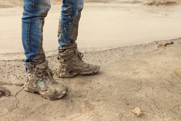Muddy and dirty Hiking Boots and blue jeans
