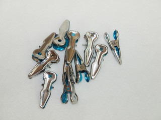 Metal clothespins silver tone in  isolated background
