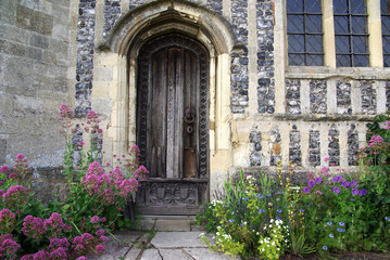 Fototapeta na wymiar Door of an English church with flowers