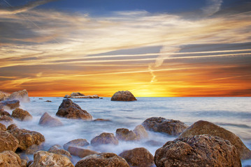 Wonderful landscape with sunset on the beach on the seashore in