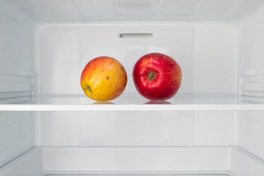 Apples in open empty refrigerator  Weight loss diet concept 