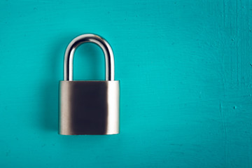 Fototapeta premium Metal padlock on wooden surface.
