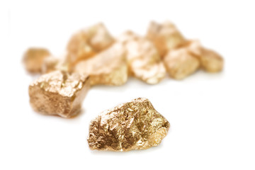 Gold nuggets on white background.