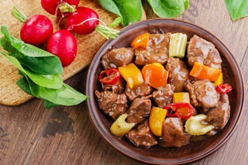 goulash meat with vegetables on the plate