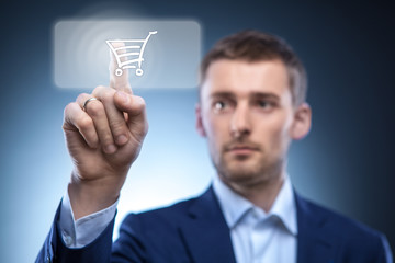 businessman press button with shopping cart