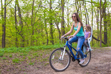 Mother and daughter riding bicycle at the park