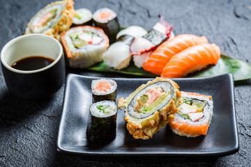 Fresh sushi on the black ceramic dish