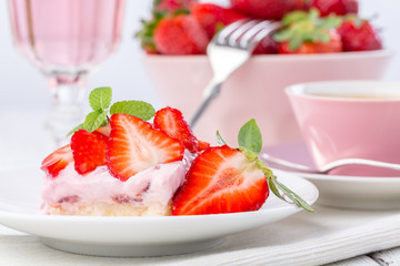Strawberry cake with coffee or tea and pink lemonade.