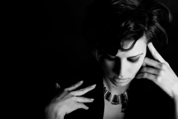 Fototapeta premium Woman with intense look on black background