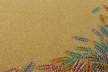 colorful paper clip on the brown board