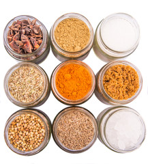 Different variety of sugar and spices over white background