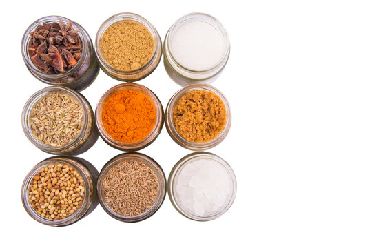 Different variety of sugar and spices over white background