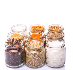 Different variety of sugar and spices over white background