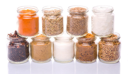 Different variety of sugar and spices over white background