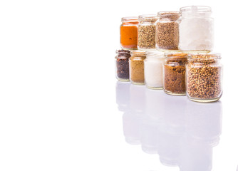 Different variety of sugar and spices over white background