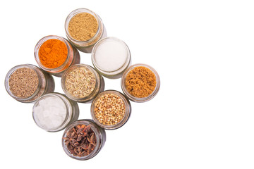 Different variety of sugar and spices over white background