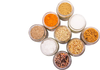 Different variety of sugar and spices over white background